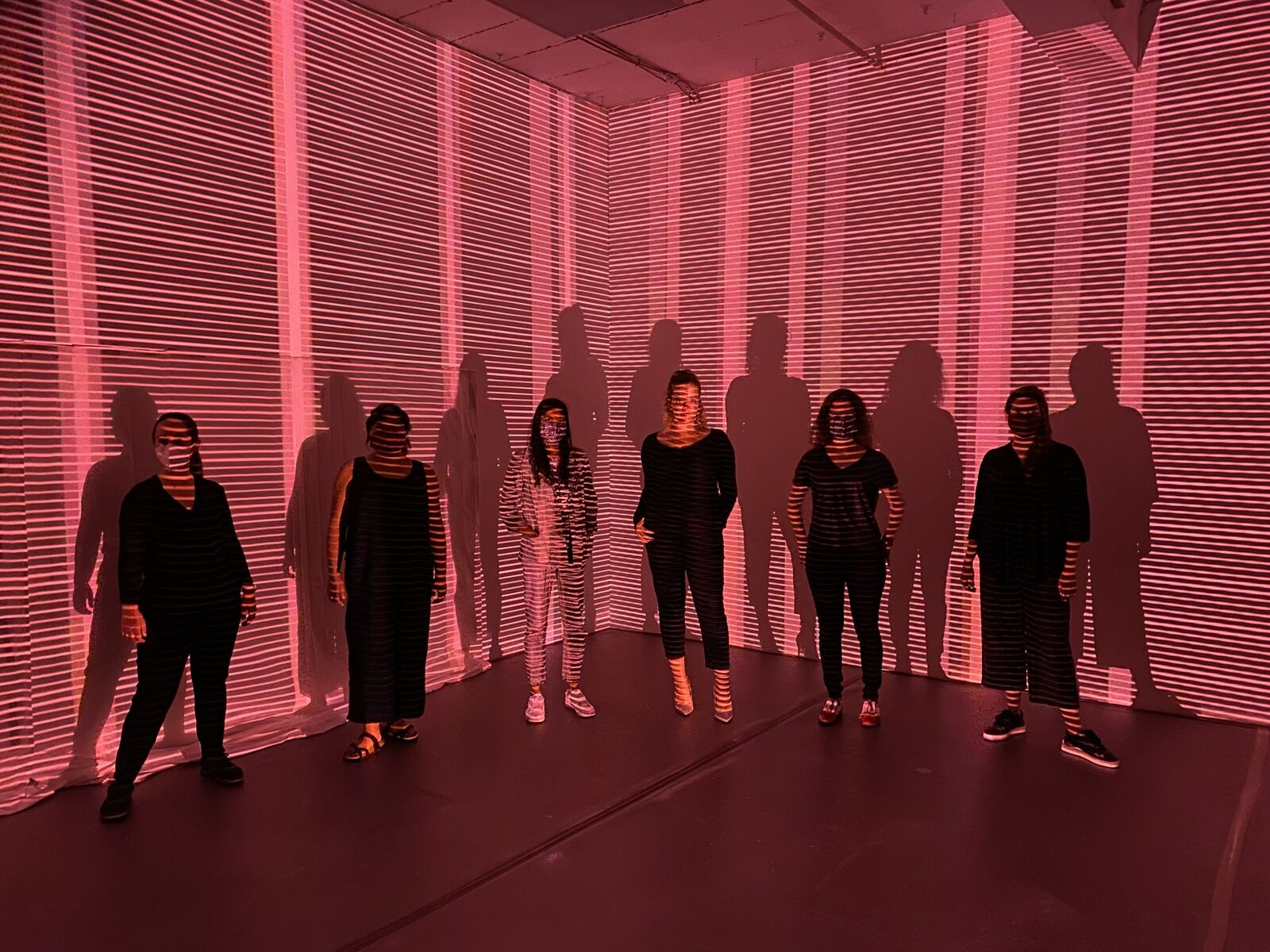 Sinéad O'Kelly R&D — performers against pink line projection